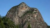 Glass House Mountains Mount Tibrogargan The face now COMPLETLY destroyed in 2004 But please note the holes from what I believe was cannon miss shots as they tryed and eventually succeeded at blowing the nose off long ago.jpg